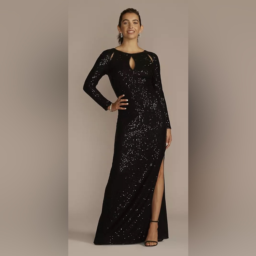 Black long sleeve Sequin gown designed with glamorous cutouts and a sexy slit.
